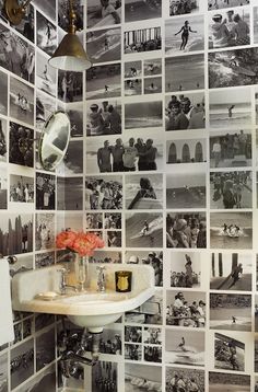 a sink and mirror in a room with pictures on the wall