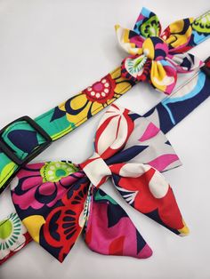 two colorful bow ties on a white surface