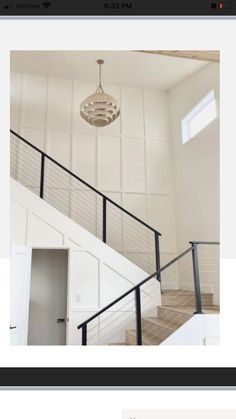 a white room with stairs and a light fixture