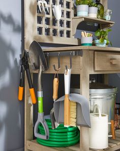 gardening utensils and garden tools are stored on a shelf