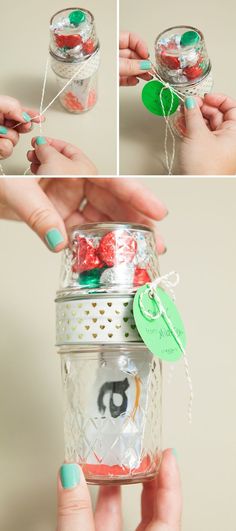 a person holding a jar with candy in it and string attached to the lid,