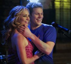 a young man and woman hugging each other in front of a microphone on the set of dancing with the stars