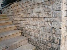 a stone wall with steps leading up to it