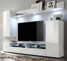 a white entertainment center with a flat screen tv mounted on it's side wall