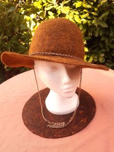 Brown felted wool hat with gold style chain. Handmade by Estambul Atelier. Materials: 100% natural and organic Merino wool. Adult - one size. **Made to Order** There may be a slight design/ colour variance compared to the images as each piece is hand made to order. Made with the wet felting technique using warm water and pure olive oil soap to blend the natural fibres into a strong and breathable fabric. I recommend hand washing, but can be machine washed using the wool/ delicate setting at a co Olive Oil Soap, Natural Fibres, Wet Felting, Felted Wool, Wool Hat, Gold Style, Natural Fibers, Wool Felt, Merino Wool