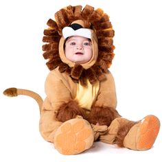 a baby in a lion costume sitting on the ground