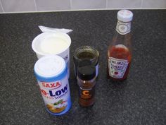 some condiments are sitting on the counter top