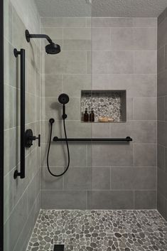 Bathroom Remodeling Ideas -  A transitional shower design with river rock floor and niche accent. Large format grey tile on the walls. Matte black fixtures. Restroom Remodel, Tub To Shower Remodel, Bathroom Remodel Master