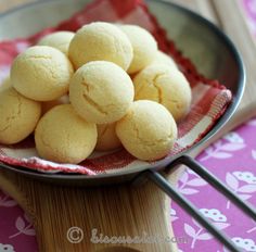 a bowl filled with cookies sitting on top of a wooden table