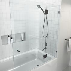 a white bathroom with a glass shower door