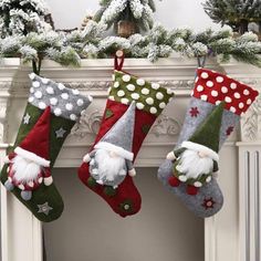 three christmas stockings hanging from a mantel