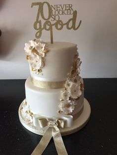 there is a white cake with gold decorations on it