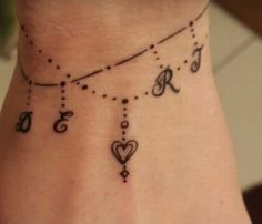 a woman's ankle tattoo with numbers and hearts on it, as well as the word love