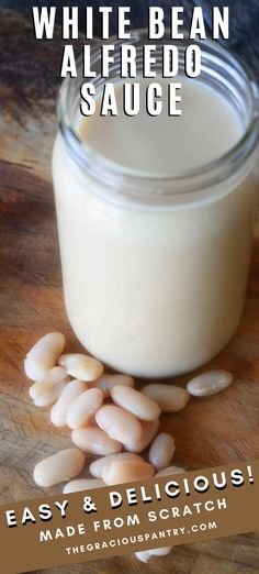 white bean alfredo sauce in a glass jar on a wooden cutting board with text overlay that reads easy and delicious made from scratch