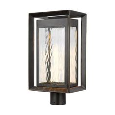 an outdoor post light that is made from metal and has frosted glass panels on the top