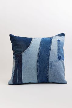 a pillow made out of blue jeans and denim fabric with an open pocket on the front