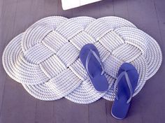 a pair of blue flip flops sitting on top of a mat