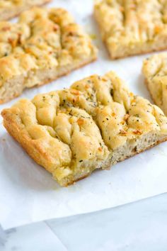 several pieces of bread sitting on top of white paper