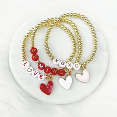 three bracelets with charms that say i love you