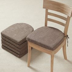 a stack of four chairs sitting next to each other on top of a carpeted floor