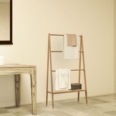 a bathroom with a shelf, mirror and towel rack