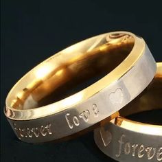 two gold wedding rings with the words forever and love engraved on each one in different languages