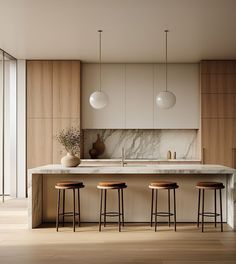 a kitchen with marble counter tops and stools next to an island in the middle