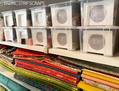 the shelves are filled with fabric and storage bins for crafting, sewing or quilting