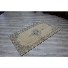 an old rug is laying on the floor