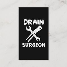 a black and white poster with the words drain surgeon on it's front, next to a wrench