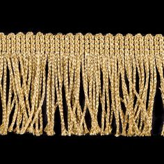 a gold chain with fringes on a black background