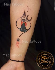 a woman's leg with a tattoo on it and an image of a demon