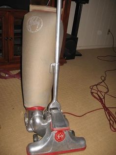 a close up of a vacuum cleaner on the floor in a room with carpeting