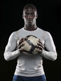 a man holding a soccer ball in his hands