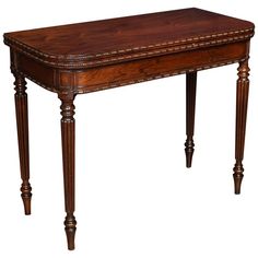 an antique wooden table with beaded trimmings on the top and bottom edge