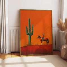 a painting of a man riding a horse next to a cactus on an orange background