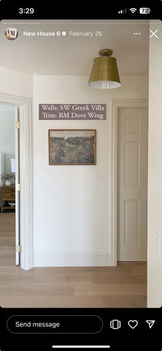 an image of a room that is white and has a sign on the wall above it