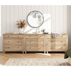 a bedroom scene with focus on the dresser and mirror, along with an area rug