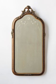 an ornate mirror hanging on the wall