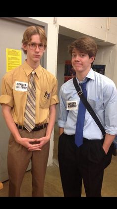 two young men wearing ties and shirts standing next to each other