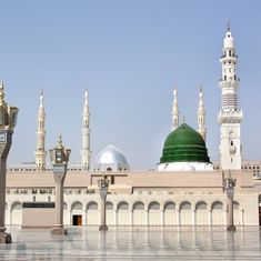 a large building with many domes and minalis on the top floor in front of it