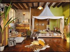 a bedroom with a canopy bed and lots of stuffed animals on the wood flooring