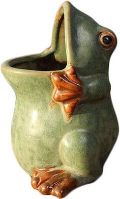 a ceramic frog planter with its mouth open