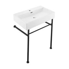 a white sink sitting on top of a black metal stand next to a white wall