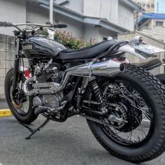 a black motorcycle parked on the street next to a building