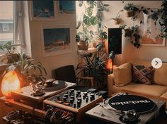 a living room filled with furniture and a record player on top of a table in front of a window