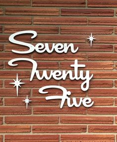 the words seven twenty five are written in white on a red brick wall with stars