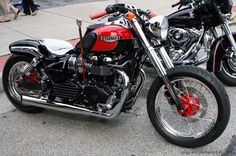 two motorcycles parked next to each other on the street