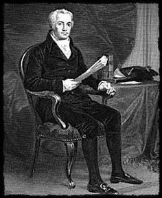 an old black and white photo of a man sitting in a chair holding a book