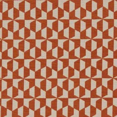 an orange and white geometric pattern on fabric